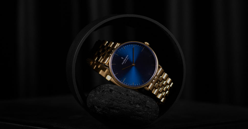 silver watch with blue face